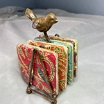 Creative Co-op Kate Mcrostie Stone Tile Look Coaster Set In Metal Bird Stand. Fixed Price $23.50.